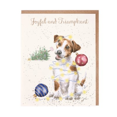 Jack Russell covered in fairy lights and baubles with a fallen tree in the background Christmas card