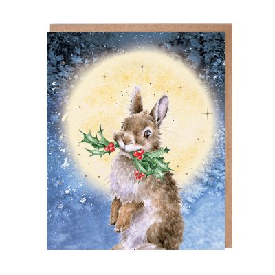 Rabbit with holly in its mouth with a large moon behind Christmas card