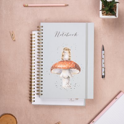 An A4 spiral bound notebook with an illustration of a mouse on a mushroom